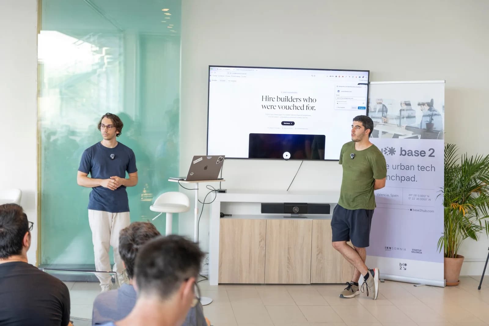 Two founders presenting their product at a demo night