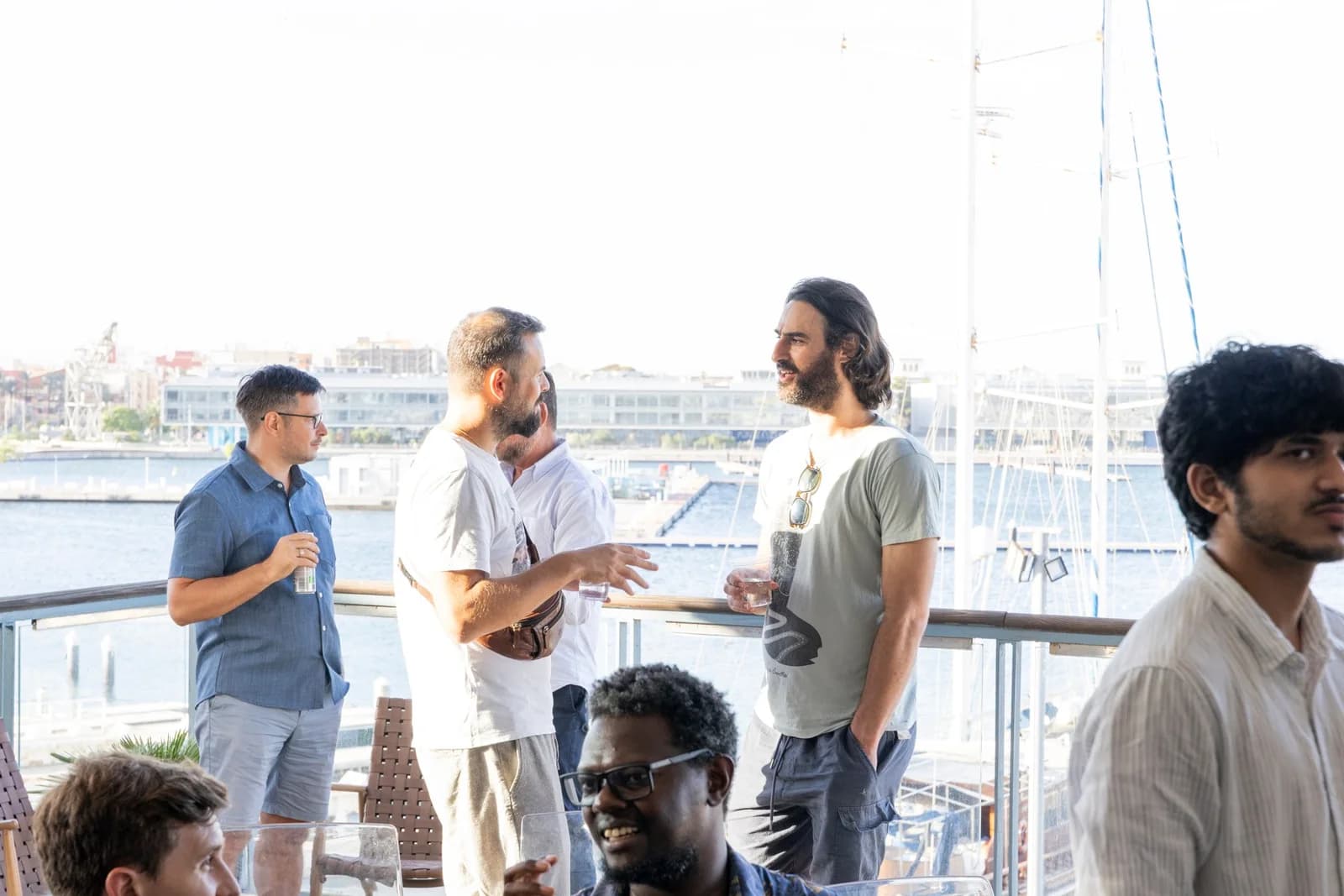 Builders on the terrace at Base 2, boats in the marina